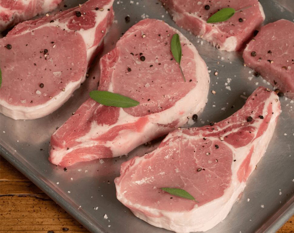 6 Quick & Easy Pork Chop Recipes You Can't Mess Up 5 raw pork chops with seasoning on a metal pan