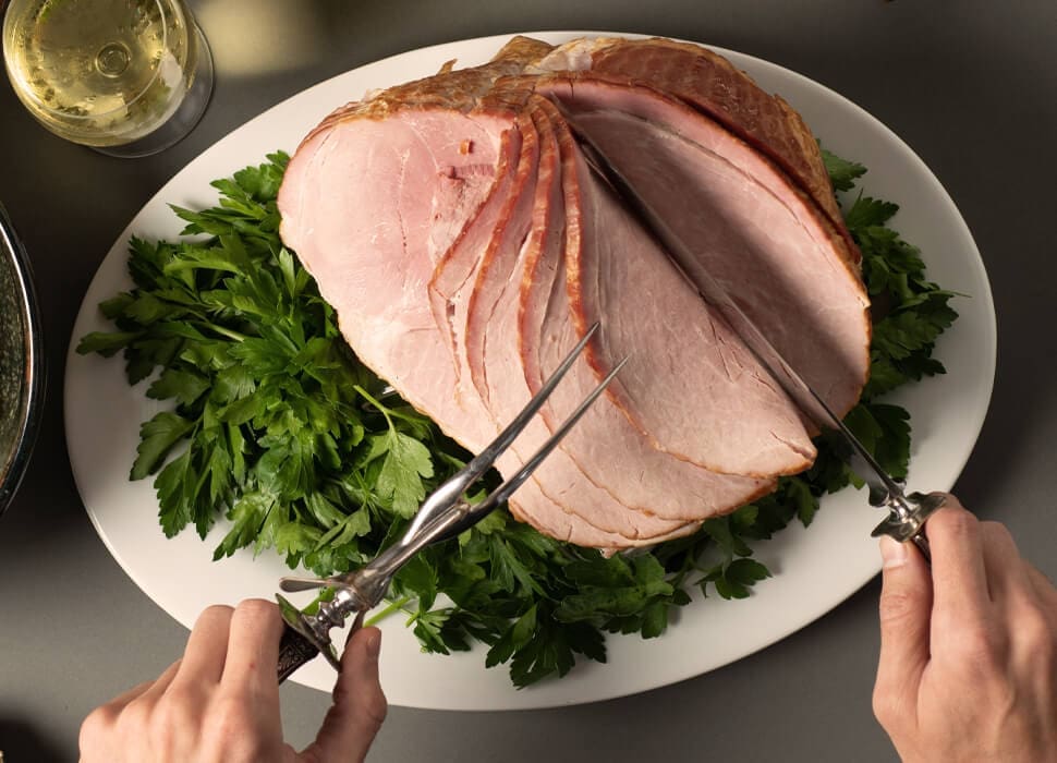 hands slicing spiral ham
