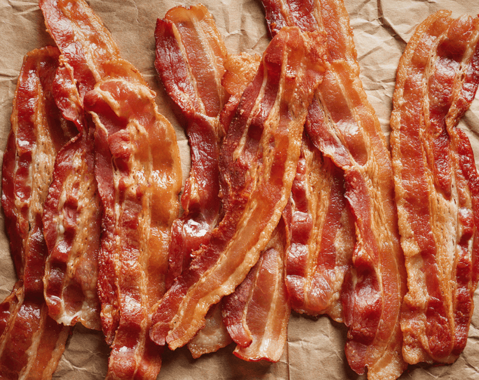 Can You Cook Bacon in an Air Fryer? 2 Strips of bacon sitting on brown paper