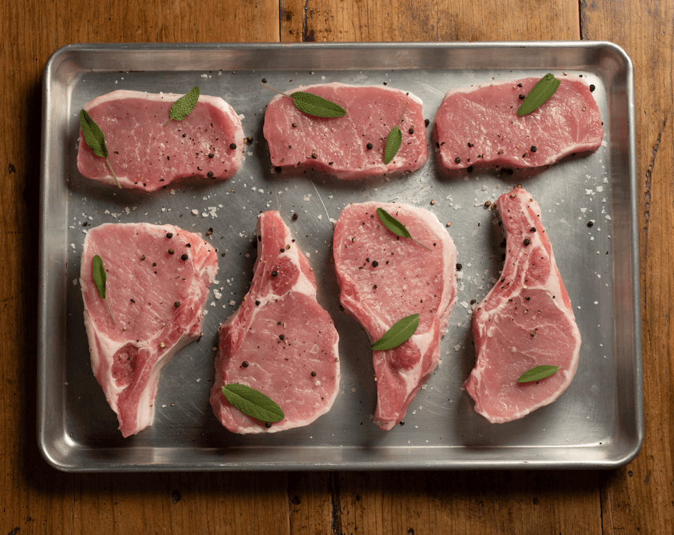 Pork Cuts 101: An Essential Guide to Different Cuts of Pork 3 Raw pork chops on a metal pan