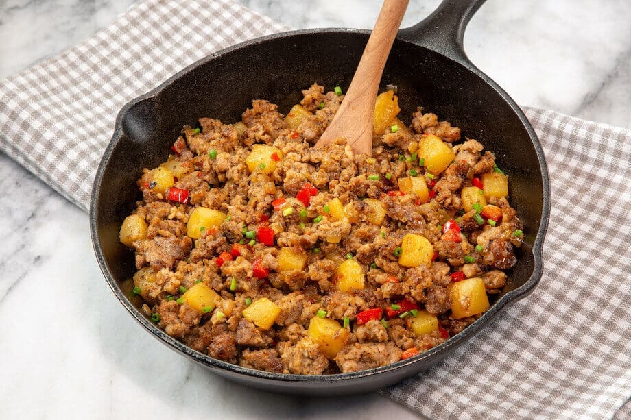 Cooked ground sausage with potatoes in a cast iron pan