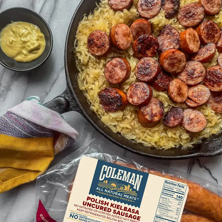 Why People Eat Pork On New Year's Day: The Story Behind the Tradition 2 kielbasa with sauerkraut in a cast iron